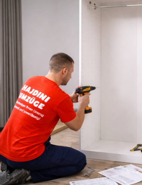 Movers assembling wardrobe in modern apartment